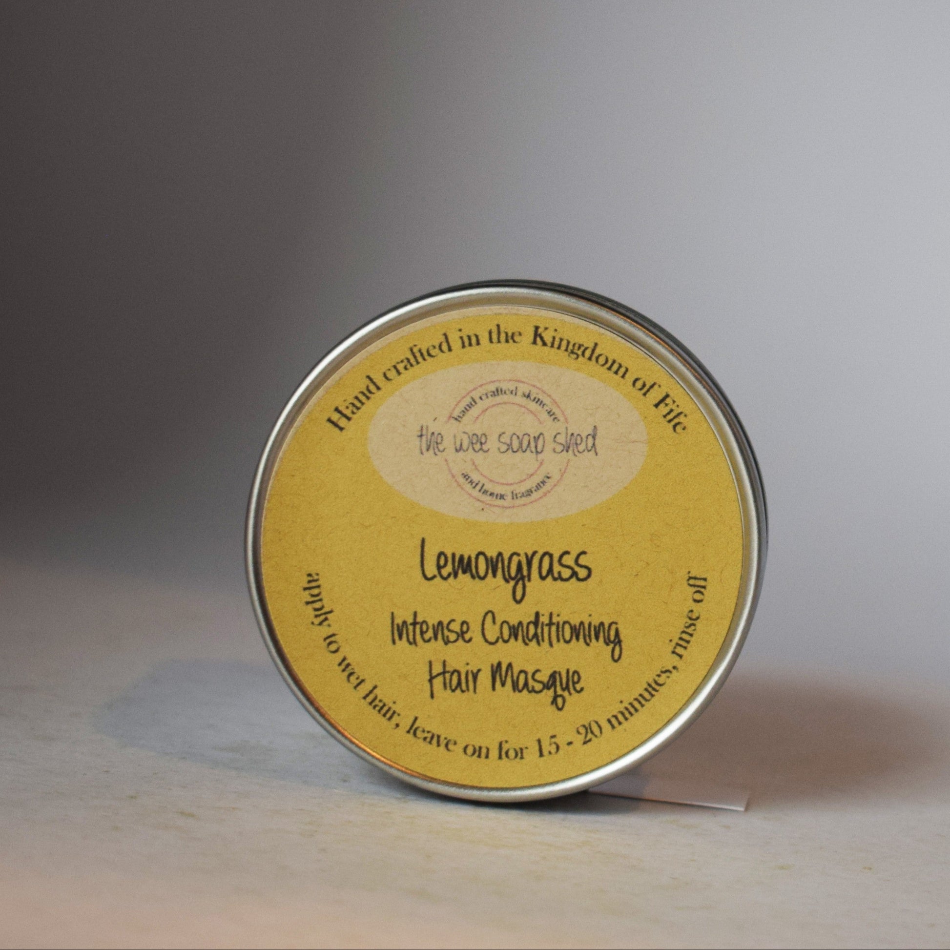 Round container with yellow label on a gray background