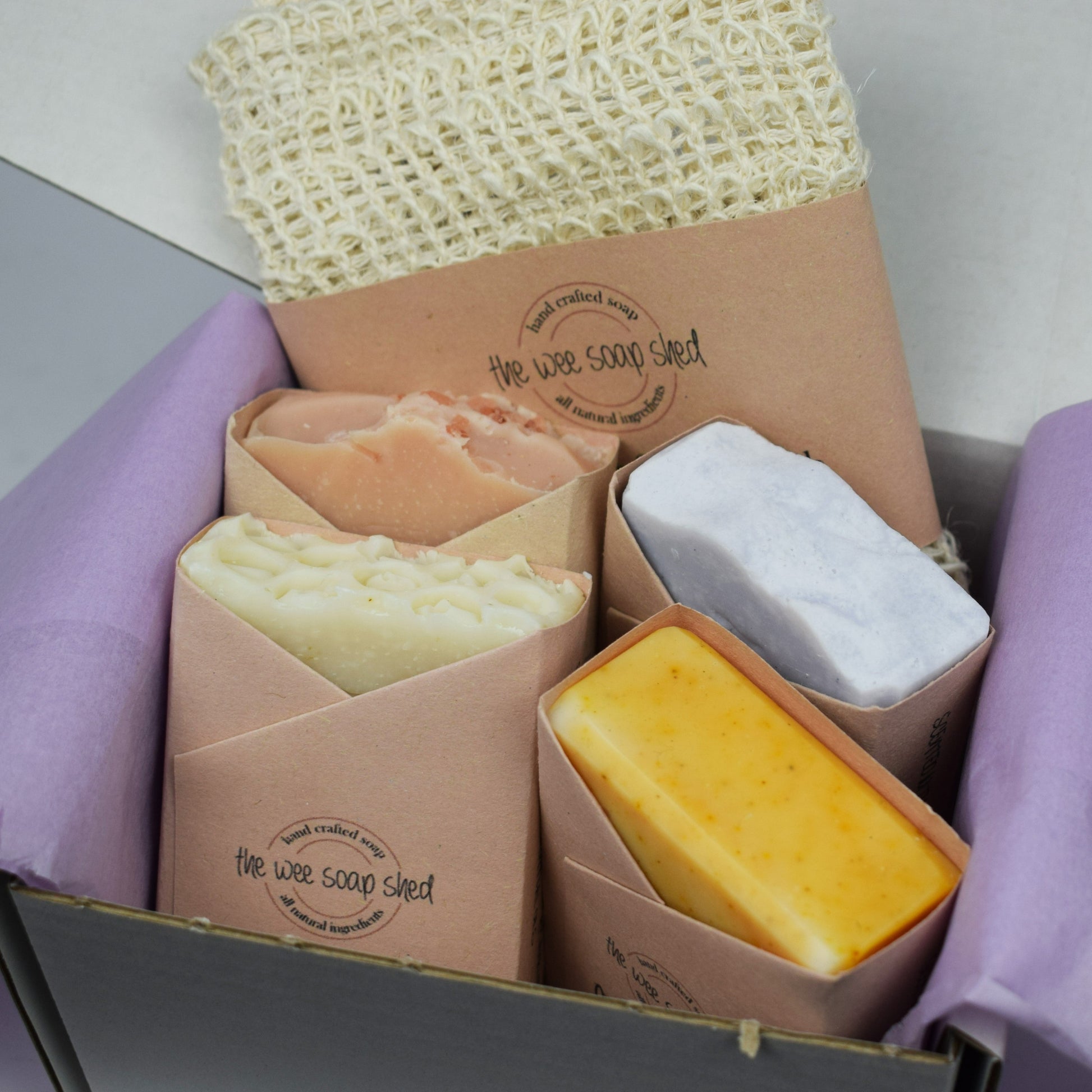 Mystery bundle containing four of our natural handmade soap bars and an exfoliating soap pouch.